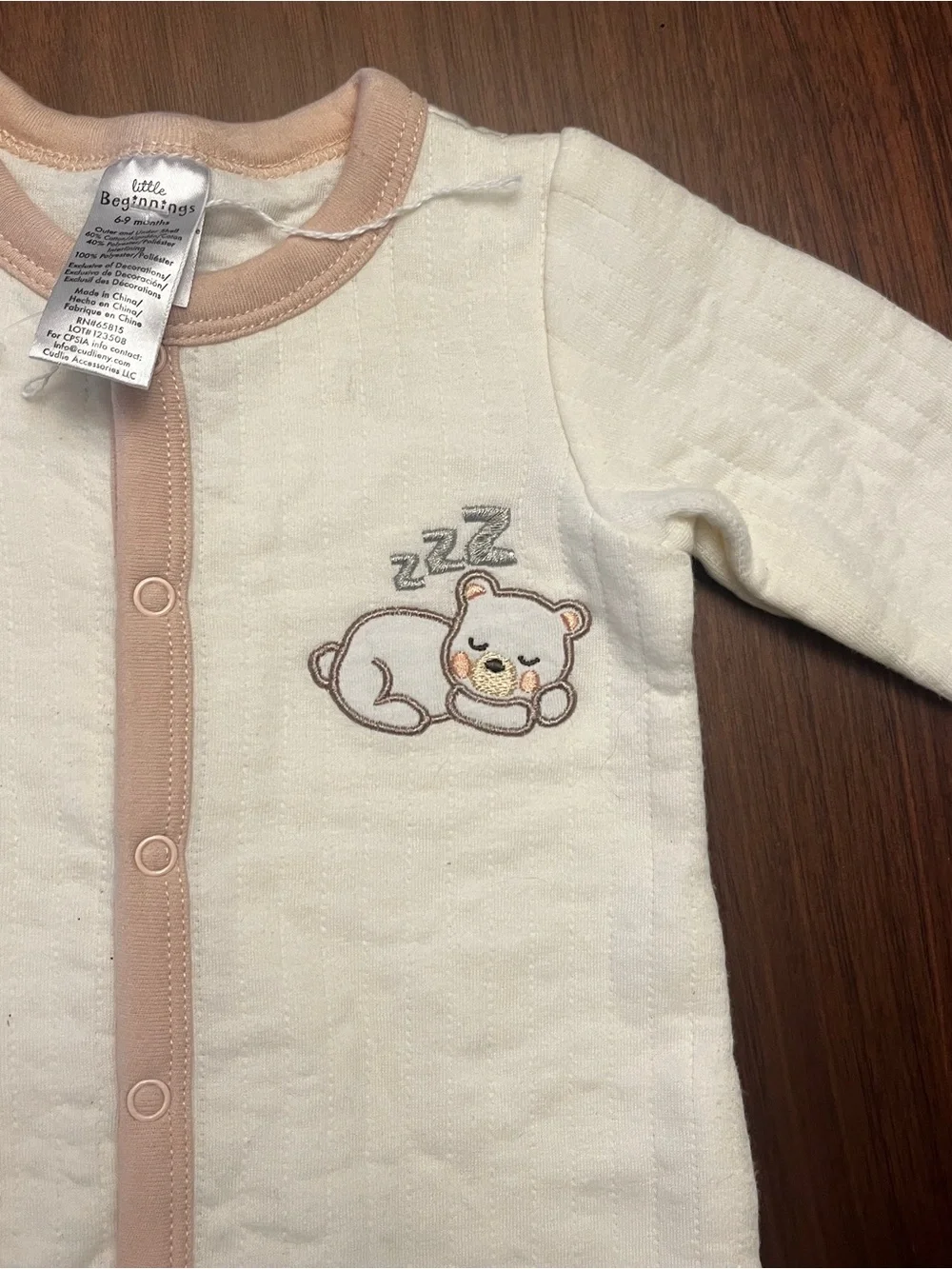 Cream Baby Footed One-Piece with Beige Trim and Sleeping Bear